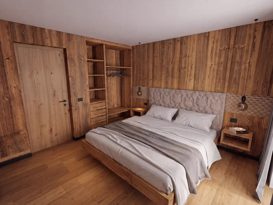 Ihr Chalet in den Dolomiten mit privater Sauna Schlafzimmer mit Holzwänden, Doppelbett und offenem Kleiderschrank